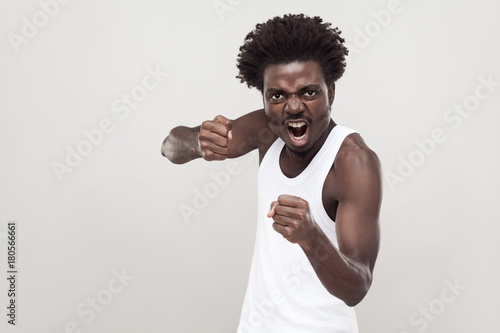 Dangerous fighter. Afro man ready to fight. Studio shot. photo