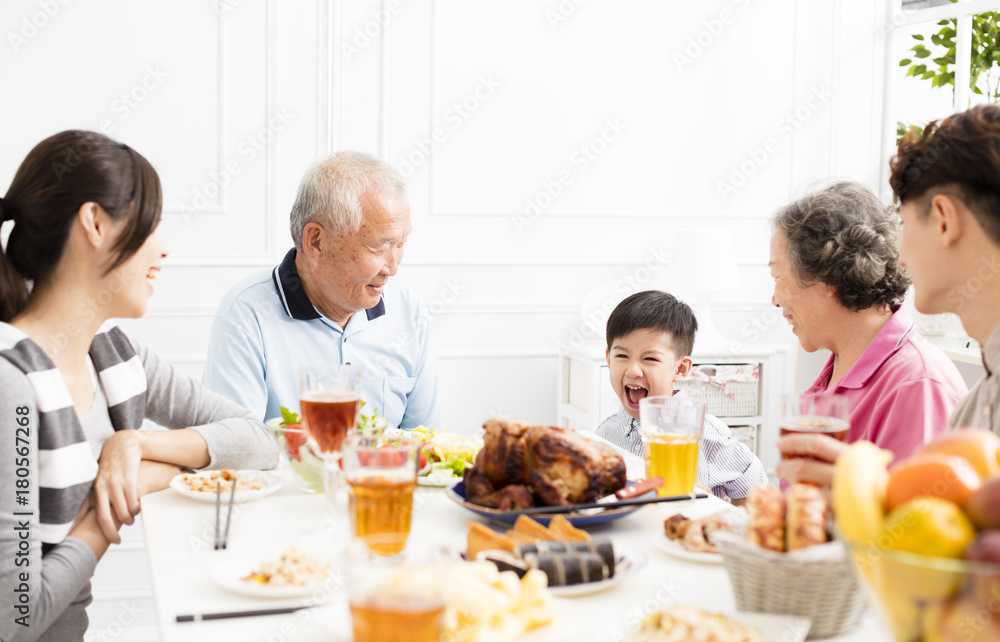 happy asian family having dinner at home