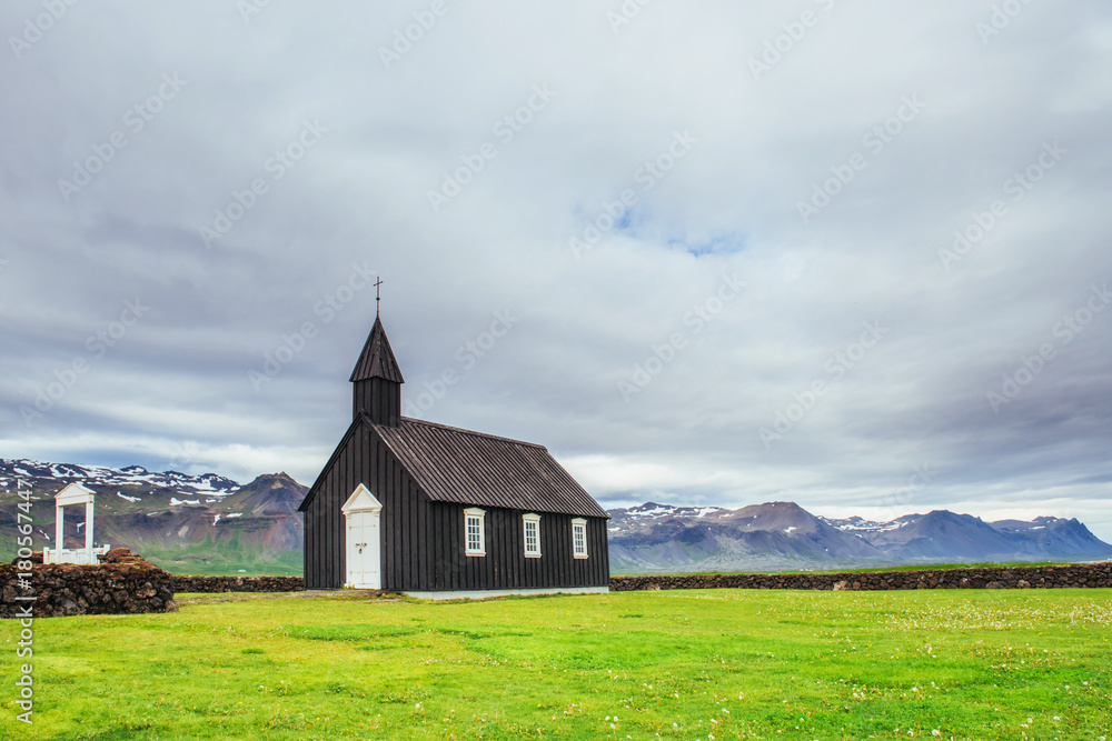 Fototapeta premium Mountain View Iceland. Beautiful black wooden church in Budir