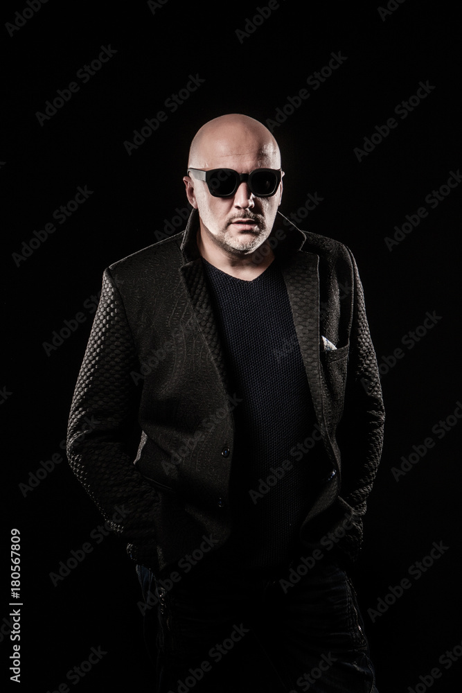 A bald man with black glasses. A bald man with black glasses.