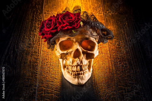 A skull with a wreath of ro...