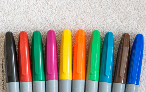 Colorful pen lids in an arc row