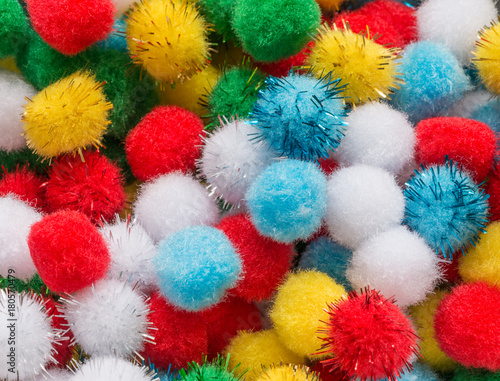 Fluffy colorful balls mixed together from above