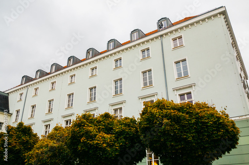 green vintage majestic building with trees