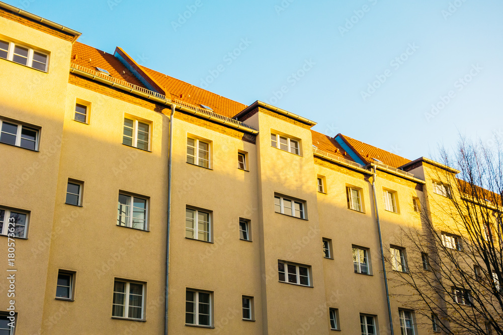 big apartment house in prenzlauer berg with warm sunlight on the facade