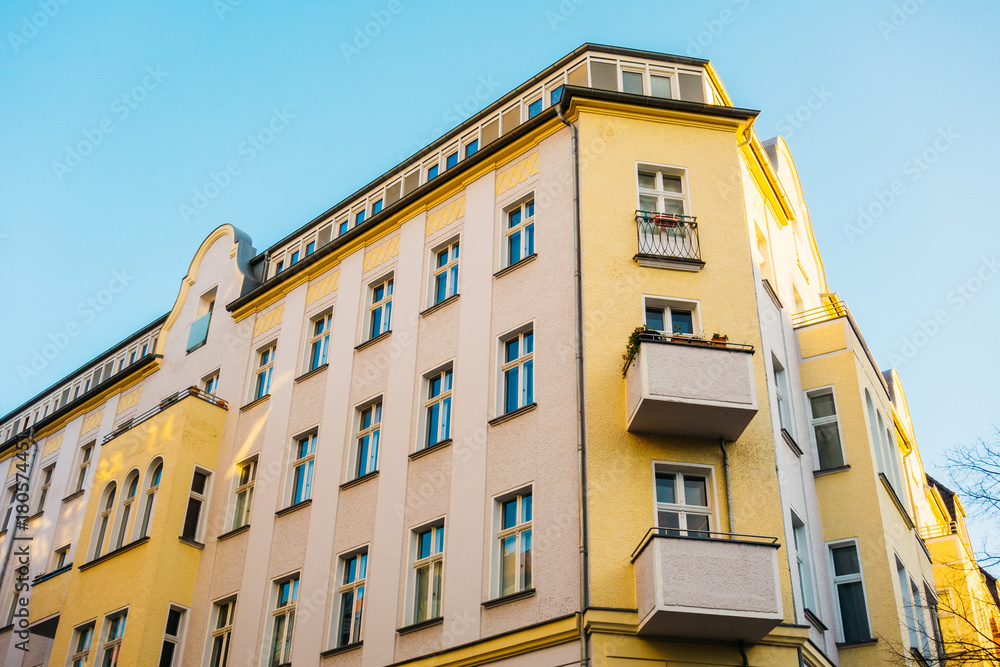 yellow and orange facaded corner building in berlin