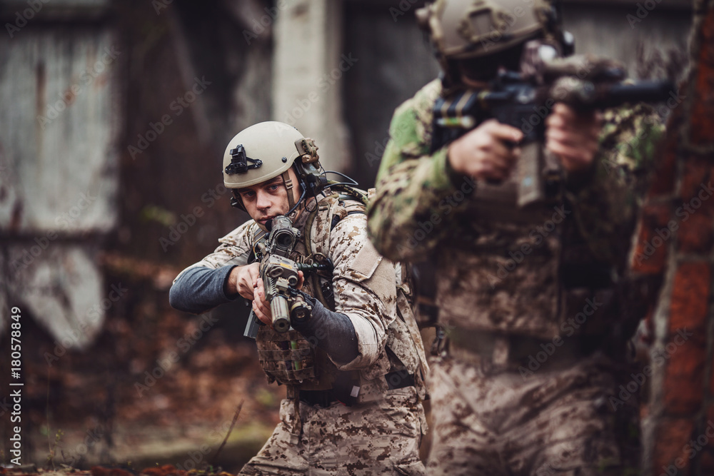 Fototapeta premium soldiers or private military contractors aiming with rifle. war, army, weapon, technology and people concept.