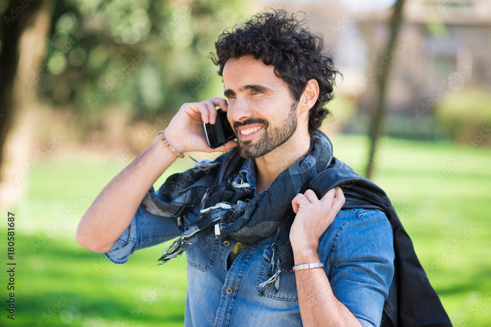 Smiling man talking on the phone Smiling man talking on the phone