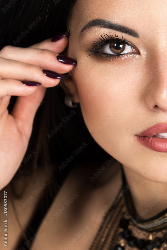 Portrait of a beautiful young dark-haired woman. Female face close up. Makeup Portrait of a beautiful young dark-haired woman. Female face close up. Makeup