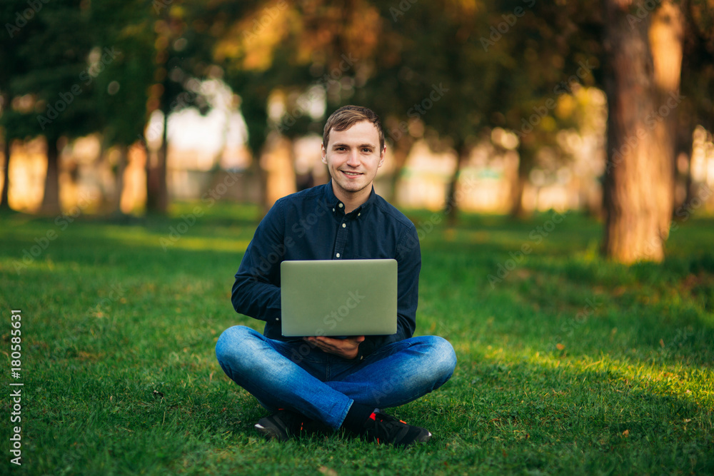 The young manager working on a laptop in the park. Lunch Break. The young manager working on a laptop in the park. Lunch Break.