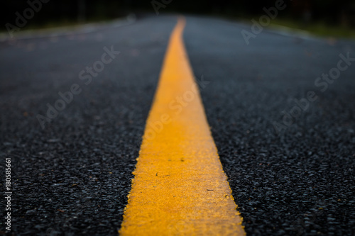 Close up line yellow asphalt road texture background.