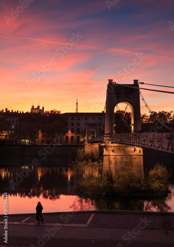 Illuminated Passerelle du College over the Rhone river during a colourful dusk. Lyon, France.