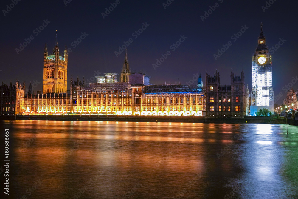 Obraz premium Night scene with light trails on the Westminster bridge. Big Ben and House of Parliament in London, The United Kingdom of Great Britain.