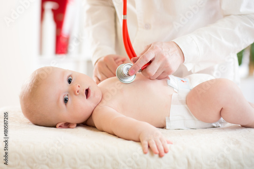 Doctor examining baby with ...