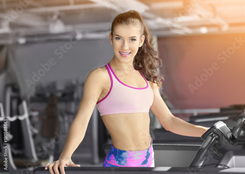 Beautiful young woman training in gym