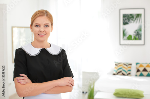 Beautiful chambermaid in room