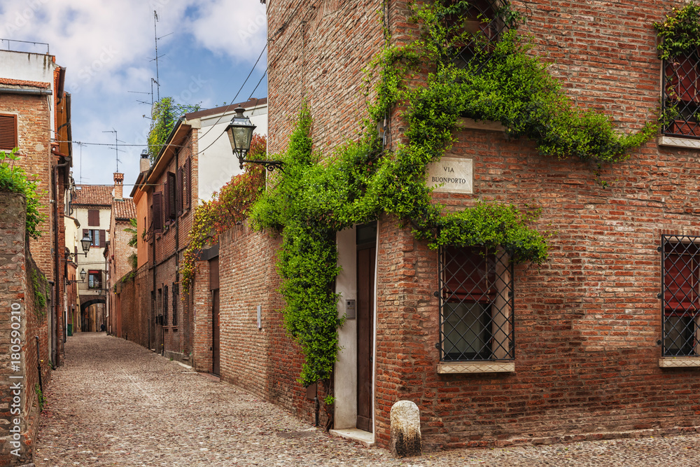 Ferrara, old narrow street, Italy