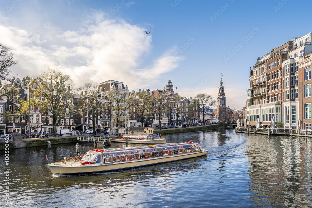 Panorama of Amsterdam with touristic boat, The Netherlands