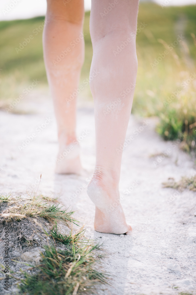 Young beautiful woman's legs walking by the path on a chalk mountain Young beautiful woman's legs walking by the path on a chalk mountain