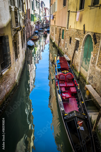 Canals and historic buildings of Venice, Italy. Narrow canals, old houses, reflection on water on a summer day in Venice, Italy.