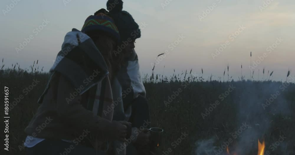two cure small friends sisters helping each other to warm up, keeping close to bonfire two cure small friends sisters helping each other to warm up, keeping close to bonfire
