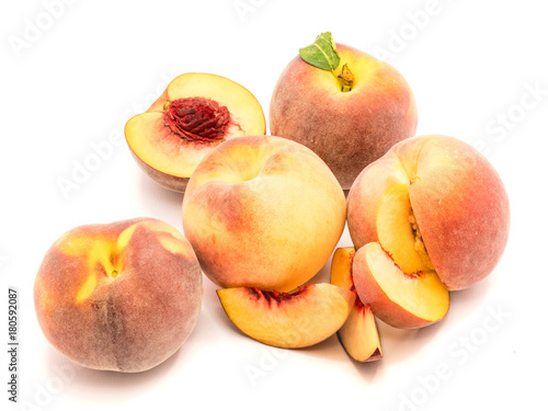 Group of peaches, sliced, halved, whole, isolated on white background.