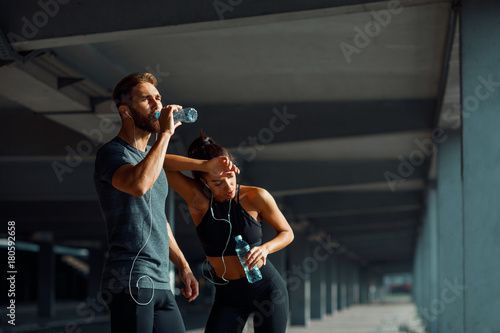 Young couple resting after jogging in the urban environment © djile