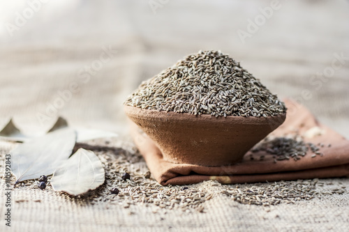 Cumin/Cuminum cyminum  in a clay bowl. photo