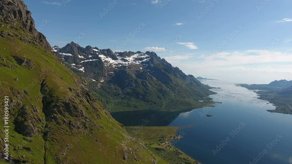 Snow peak mountain next to norwegian fjord Snow peak mountain next to norwegian fjord