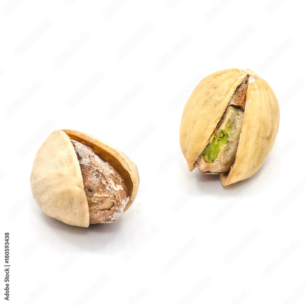 Two whole open pistachio nuts isolated on white background. Two whole open pistachio nuts isolated on white background.