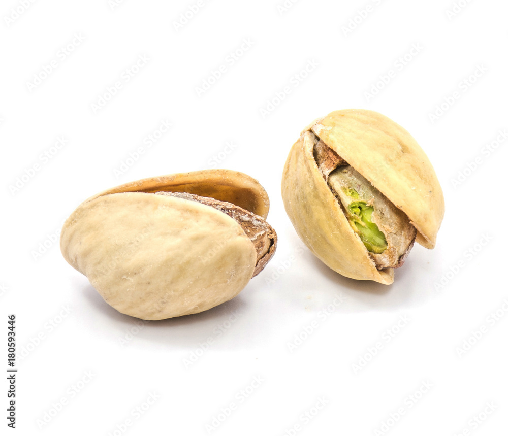 Two whole open pistachio nuts isolated on white background. Two whole open pistachio nuts isolated on white background.