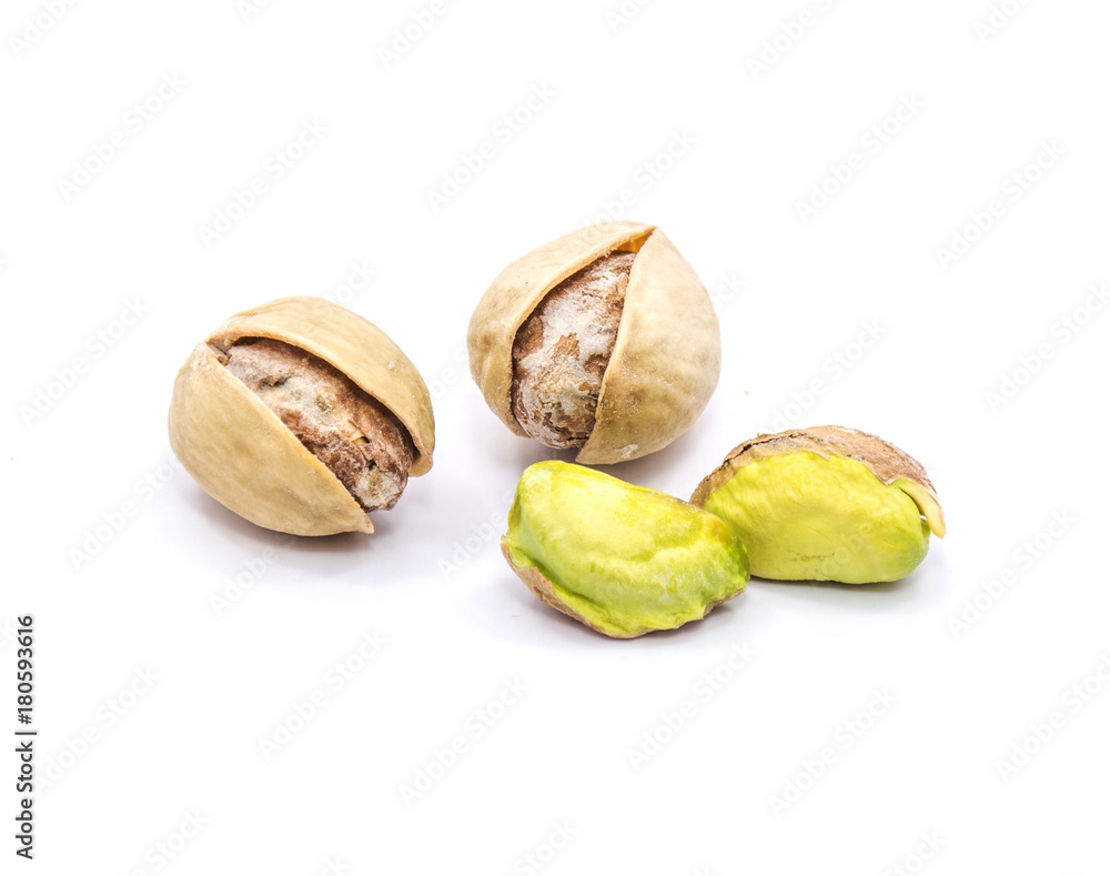 Two opened pistachio nuts, two without shells, isolated on white background. Two opened pistachio nuts, two without shells, isolated on white background.