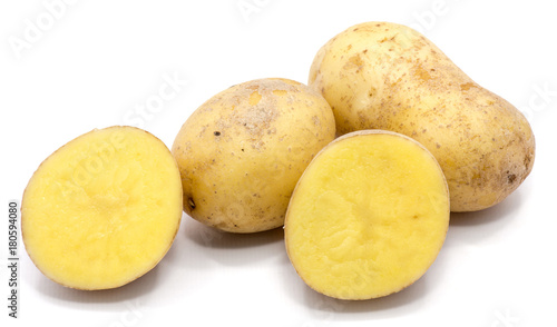 Two whole potatoes and two halves isolated on white background.