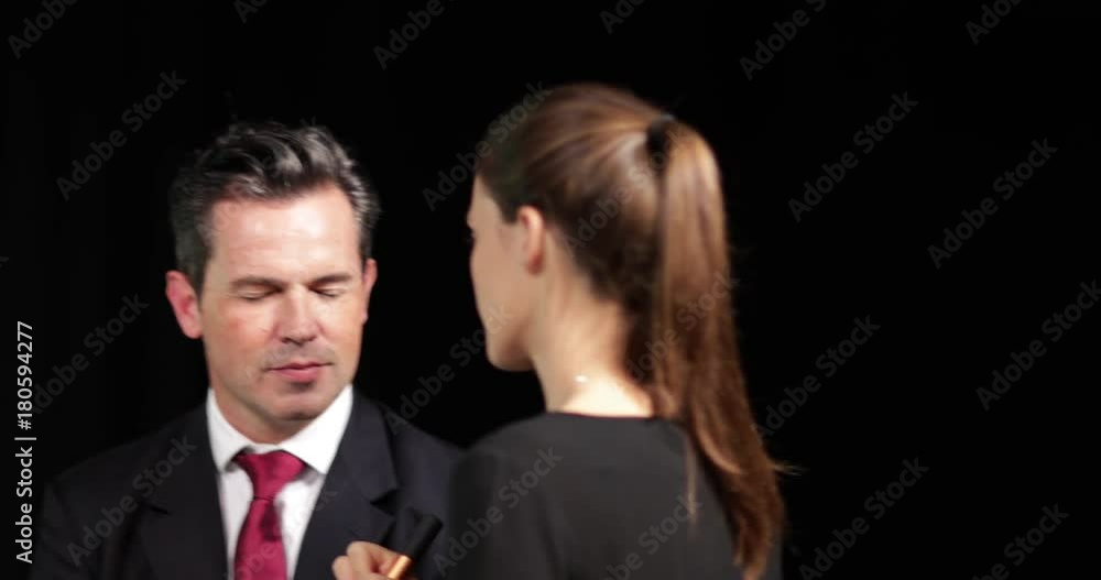 TV presenter having make-up applied on set TV presenter having make-up applied on set