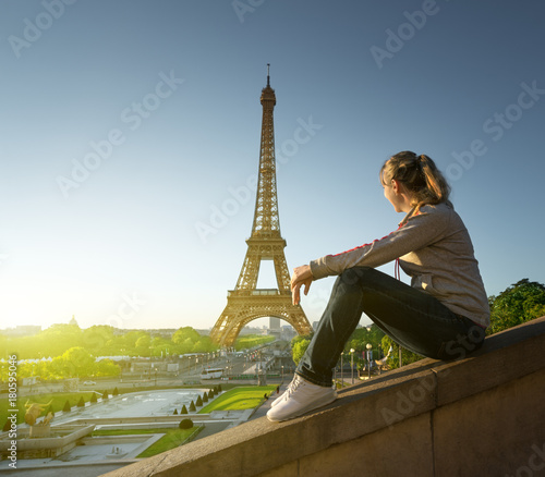 girl looking at the Eiffel tower in sunrise time, Paris © Iakov Kalinin