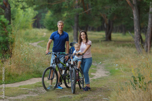 Bicyclist family, leisure in pine forest