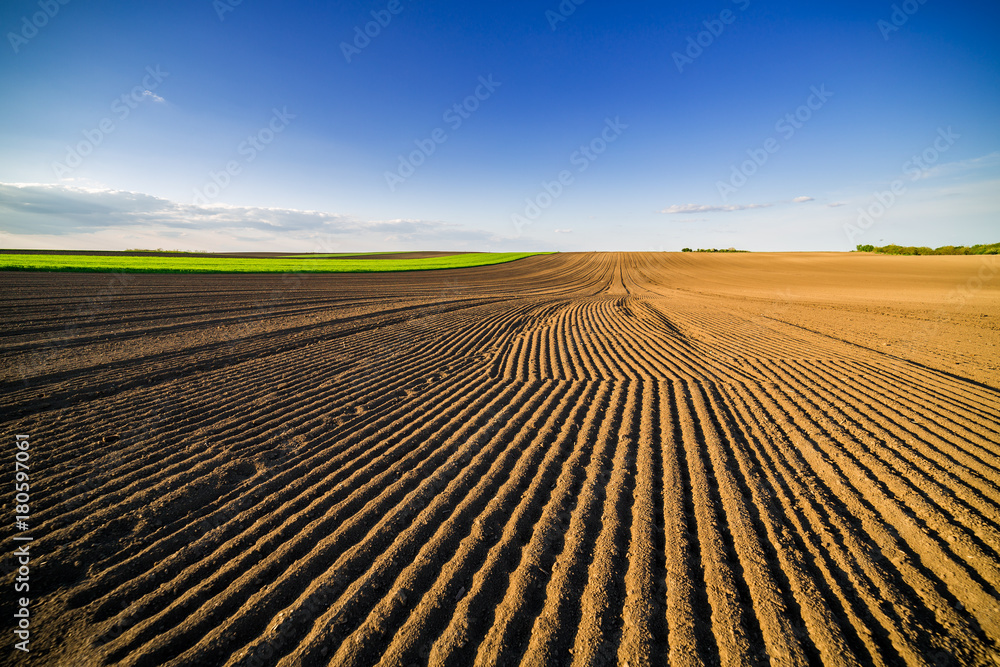 Agricultural landscape, arable crop field. Arable land is the land under temporary agricultural crops capable of being ploughed and used to grow crops. Agricultural landscape, arable crop field. Arable land is the land under temporary agricultural crops capable of being ploughed and used to grow crops.