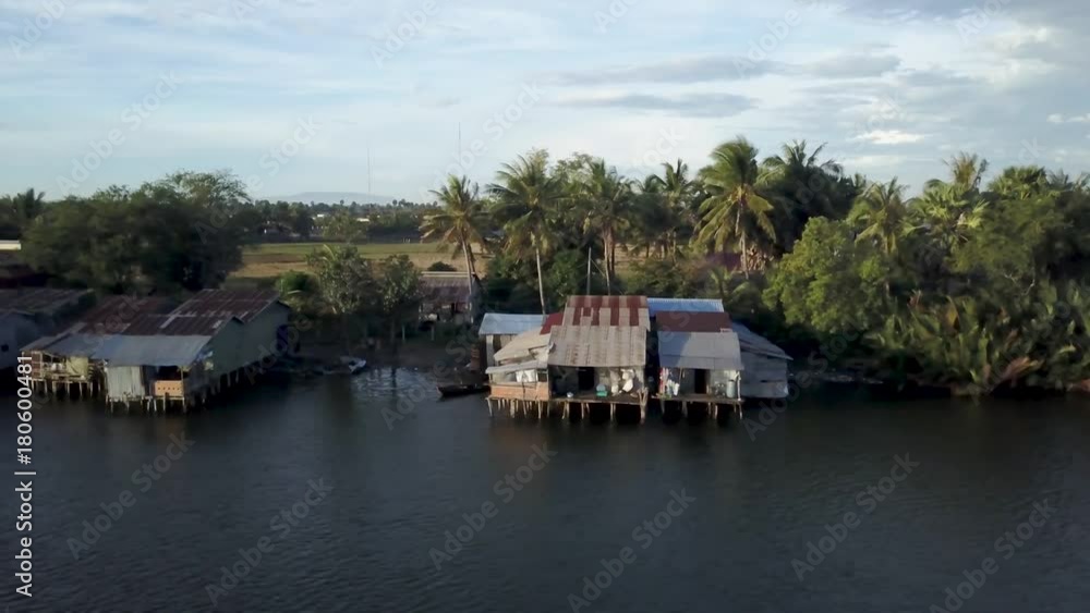 Traditional Cambodian fishing village on the east side of the Prek Kampong across the river from Kampot, Cambodia, shot at sunrise. Traditional Cambodian fishing village on the east side of the Prek Kampong across the river from Kampot, Cambodia, shot at sunrise.