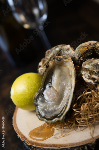 Oysters and white wine on wood background seafood