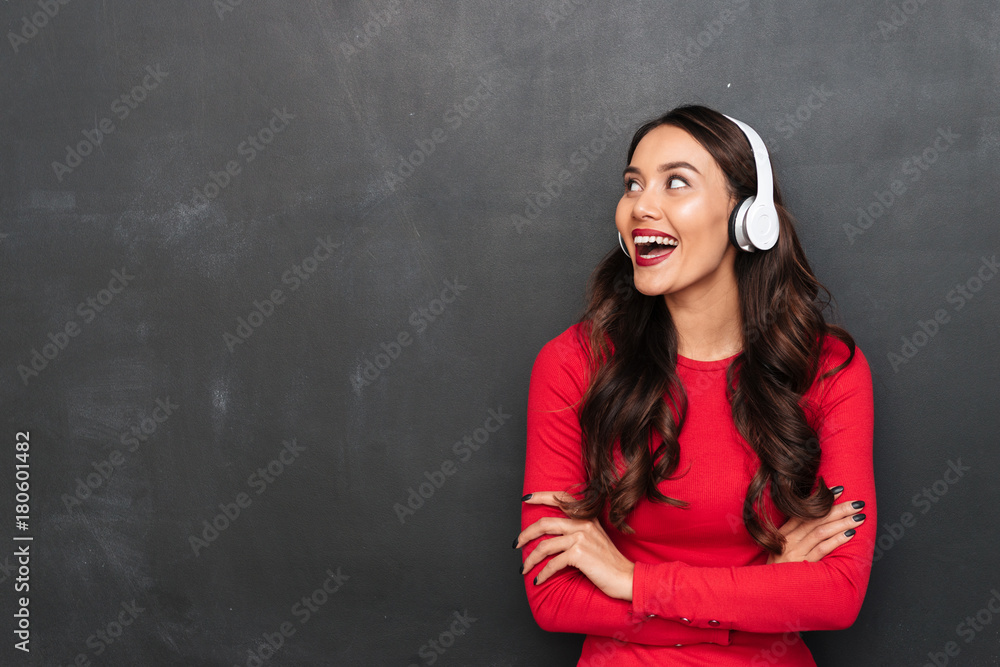 Cheerful brunette woman in red blouse and headphones Cheerful brunette woman in red blouse and headphones