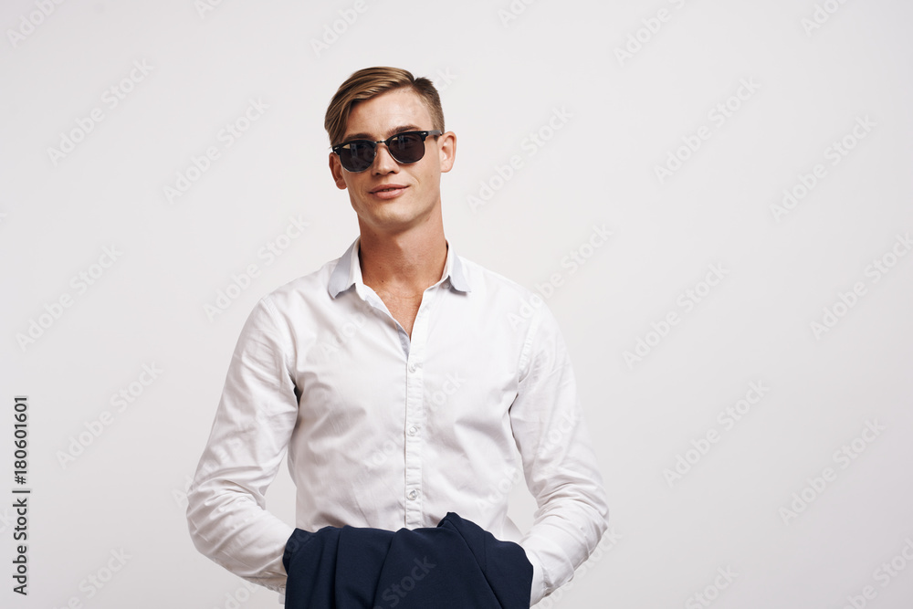 young guy in a white shirt on a light background young guy in a white shirt on a light background