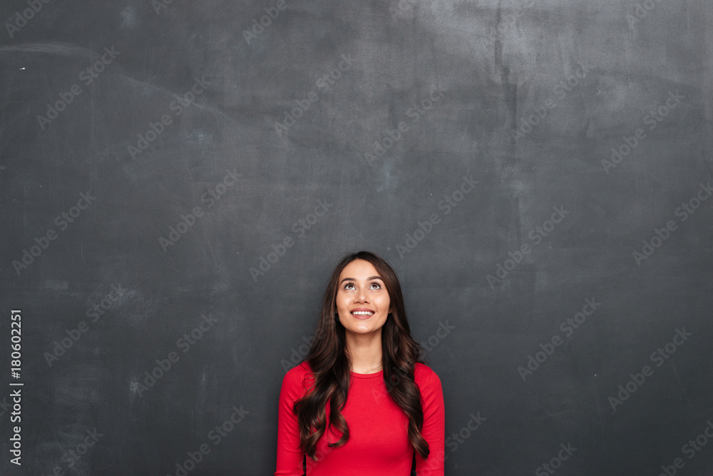 Picture of Happy brunette woman in red blouse looking up Picture of Happy brunette woman in red blouse looking up