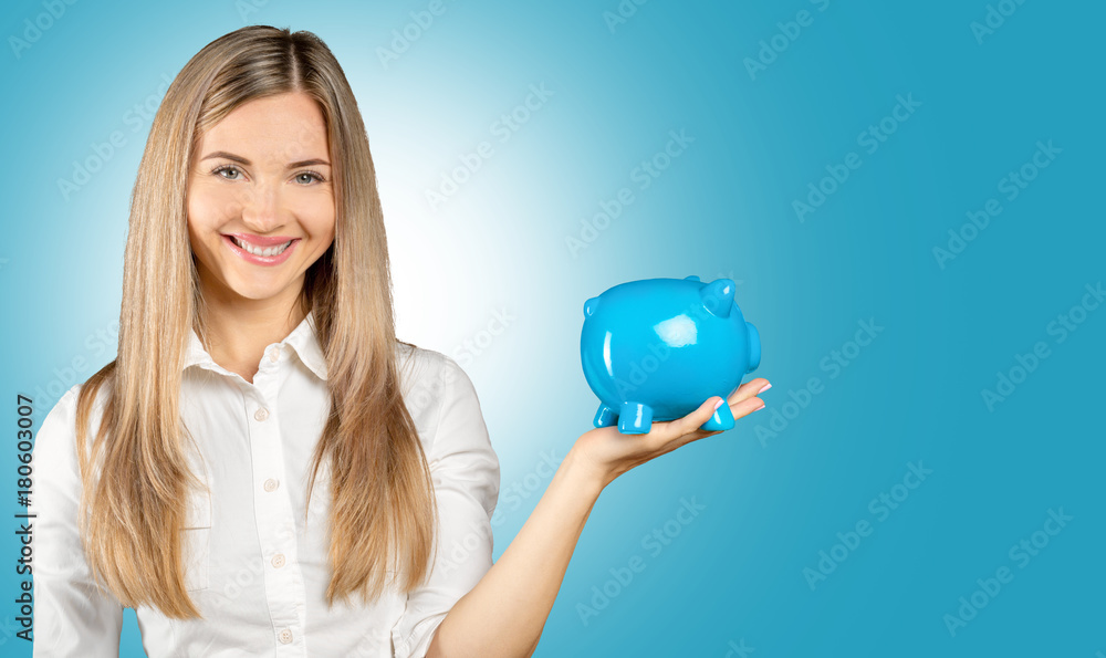 Fototapeta premium Young woman with piggy bank