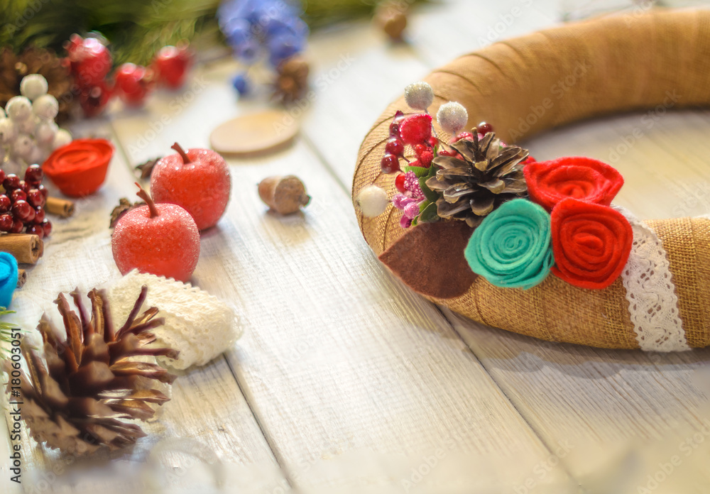 Christmas wreath and ribbon bow on a wooden board background. Christmas decoration.