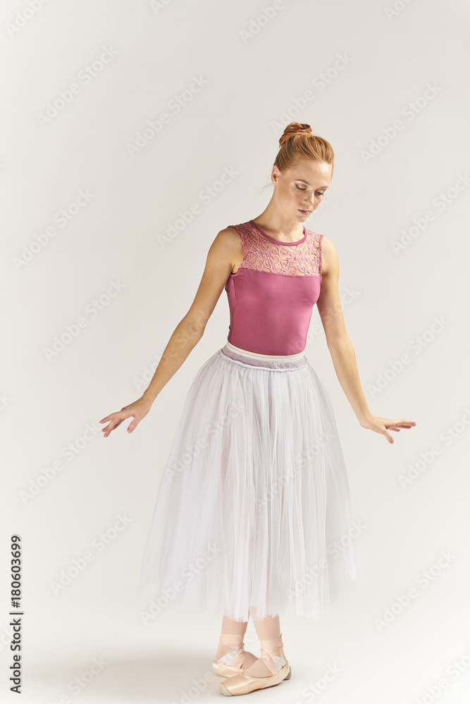 ballerina in pink posing against a light background ballerina in pink posing against a light background