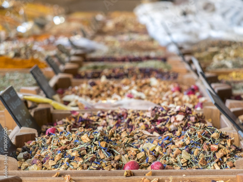 small wooden crates with various types of minced spices and grains: curcuma, curry, cajun, keufta, paprika and various infusions.