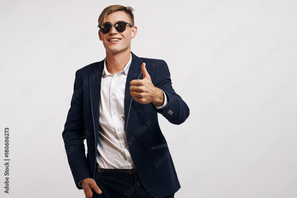 young guy in jacket shows thumb up young guy in jacket shows thumb up