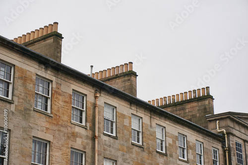 Canvas Print Rows of chimneys on a historic tenement building made of beige sandstone, typica