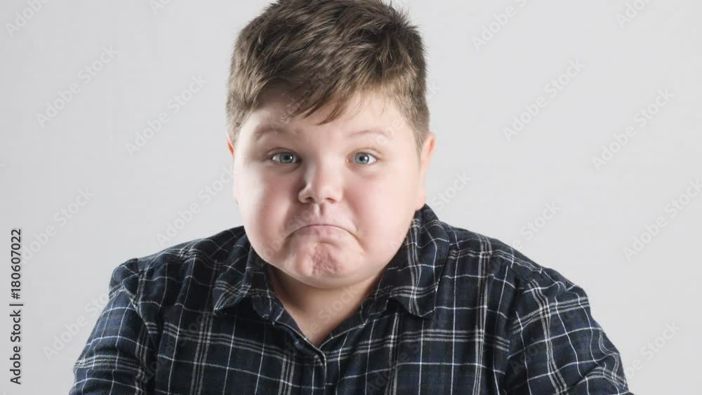 Young fat boy shows anger, aggression and hatred Young fat boy shows anger, aggression and hatred