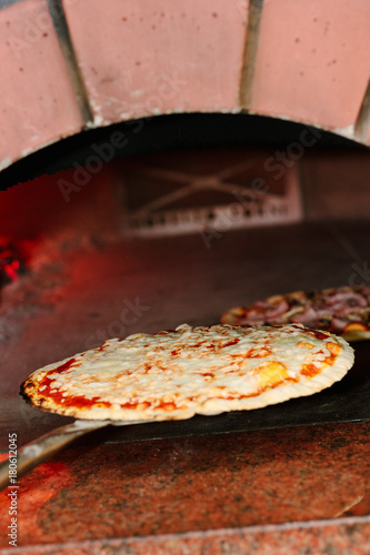 Chief taking pizza from the...